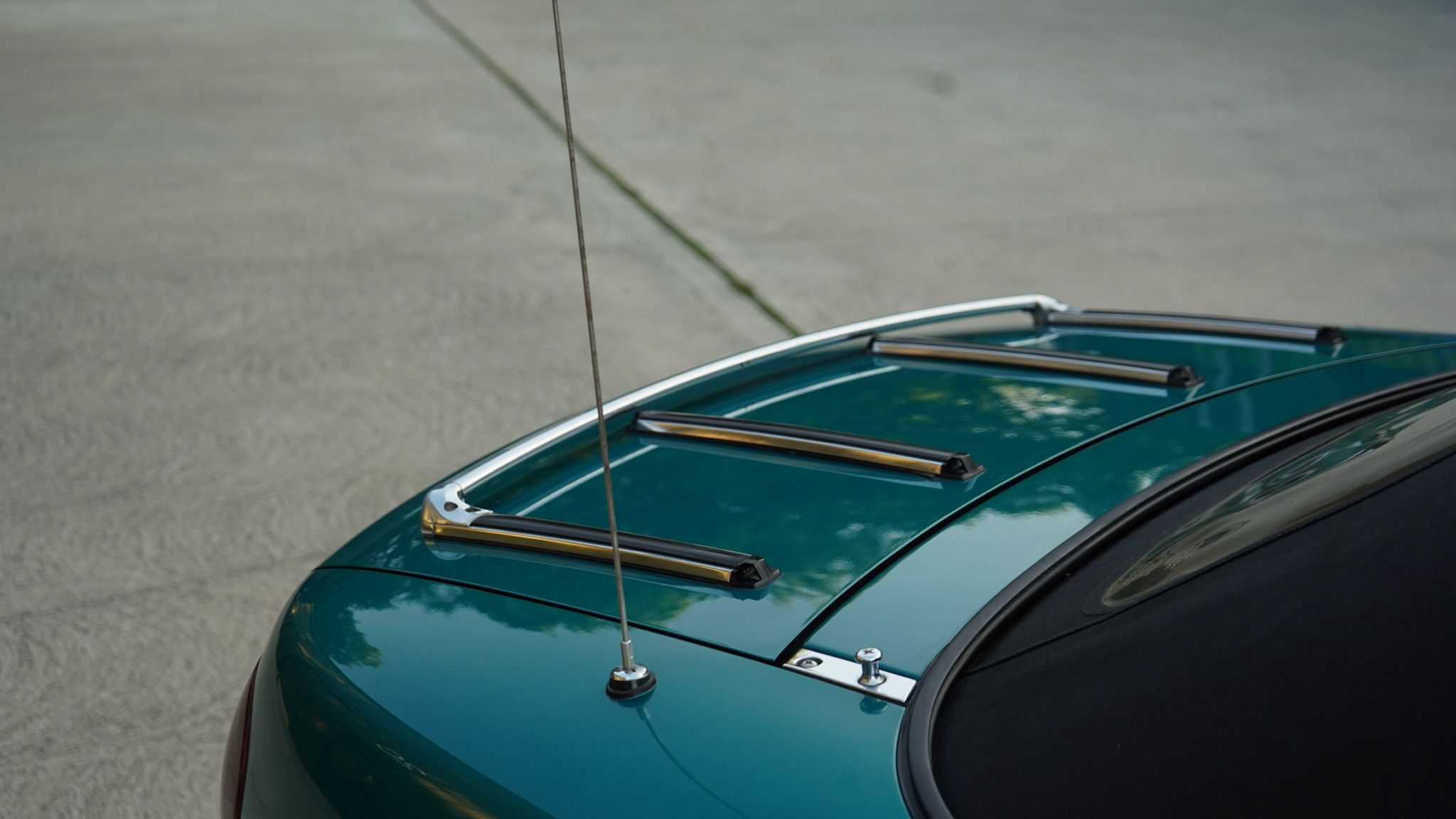 Green 1998 Mazda MX-5 Berkeley Edition showing the aerial and luggage rack detail.