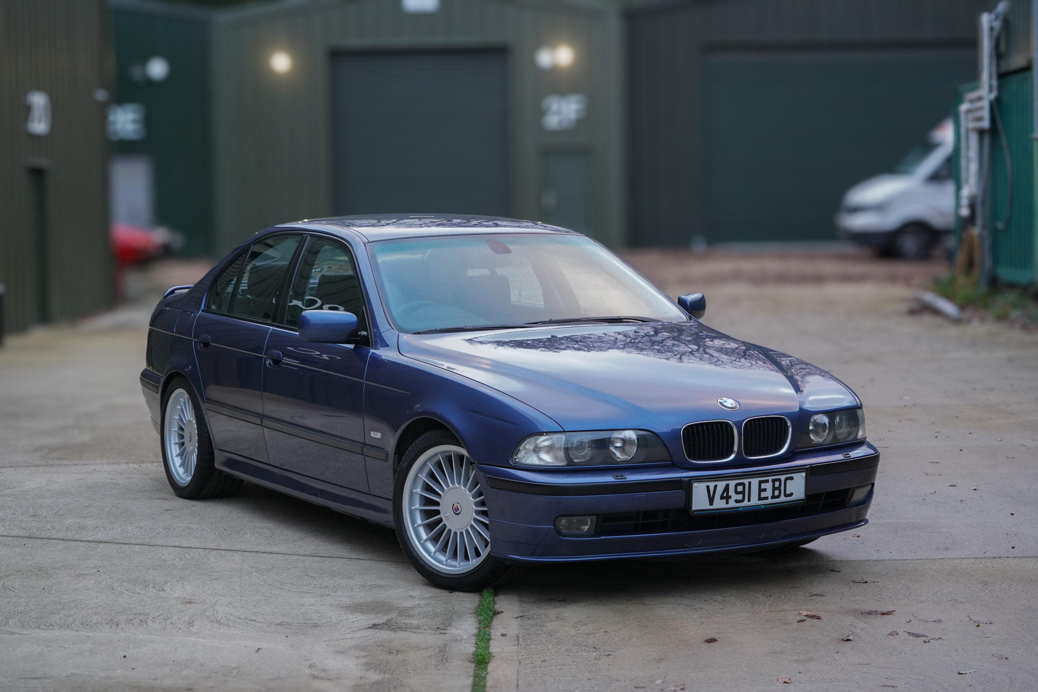 Blue 1999 BMW Alpina B10 3.3 (E39) Manual in a distant front three-quarter view.