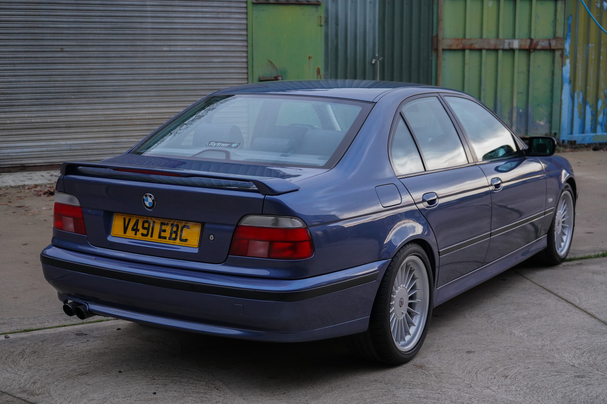 Blue 1999 BMW E39 Alpina B10 3.3 Manual in a rear three-quarter view.