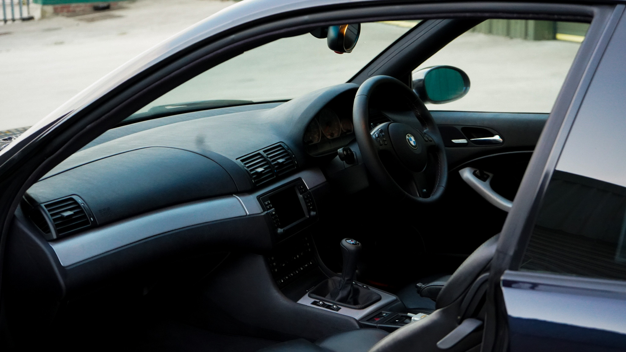 2002 BMW M3 (E46) Manual interior showing the dashboard steering wheel and cabin.