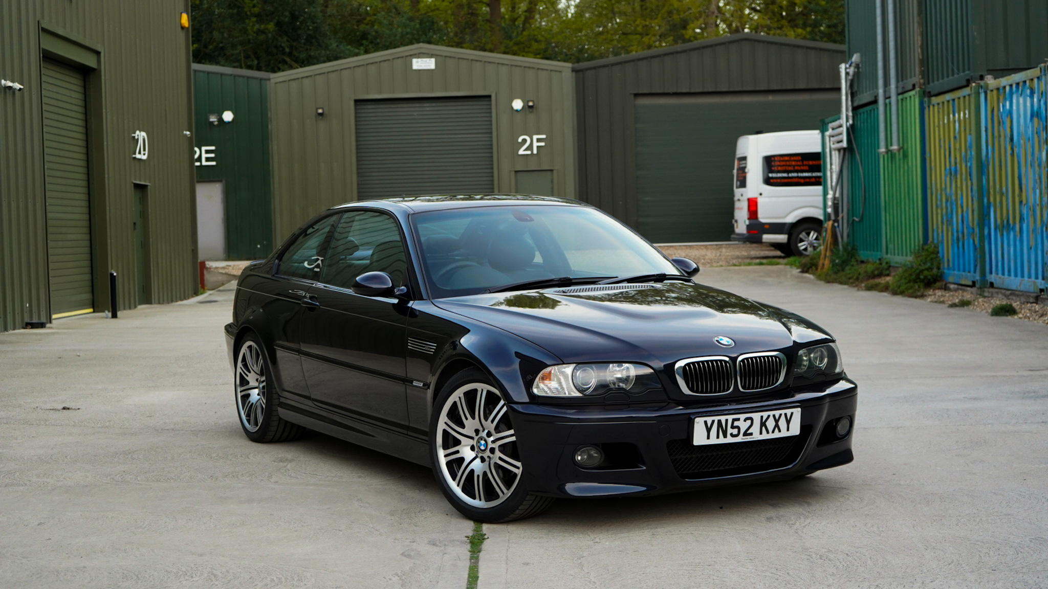 Black 2002 BMW M3 (E46) Manual in a wide front three-quarter view.