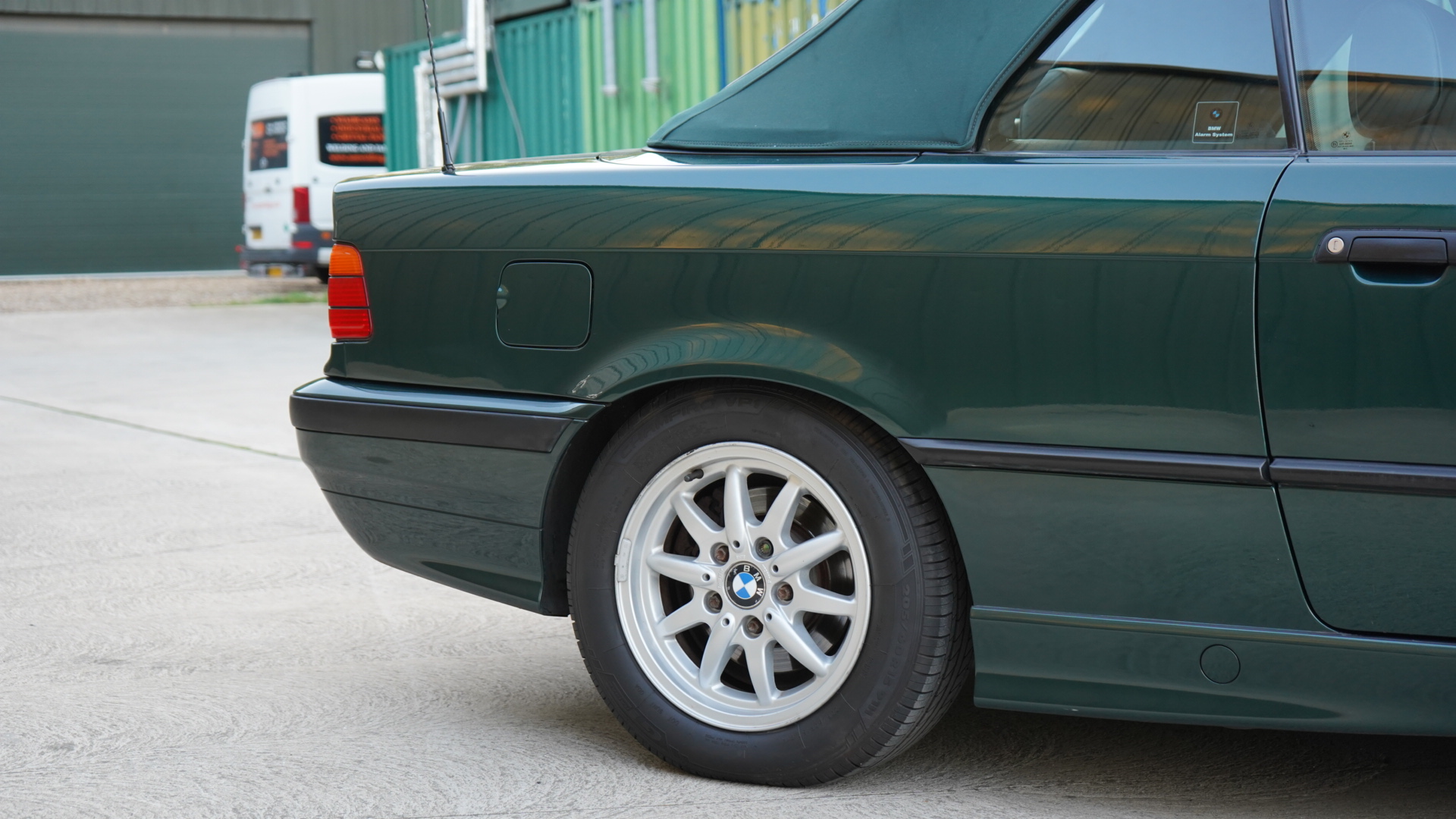 Dark green BMW 328i (E36) Manual Convertible showing the rear wheel and quarter side.