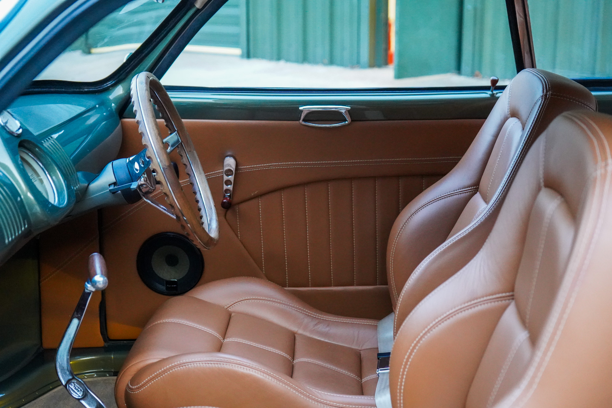 Volkswagen Karmann Ghia Type 14 Restomod interior showing the front seat steering wheel and shifter.