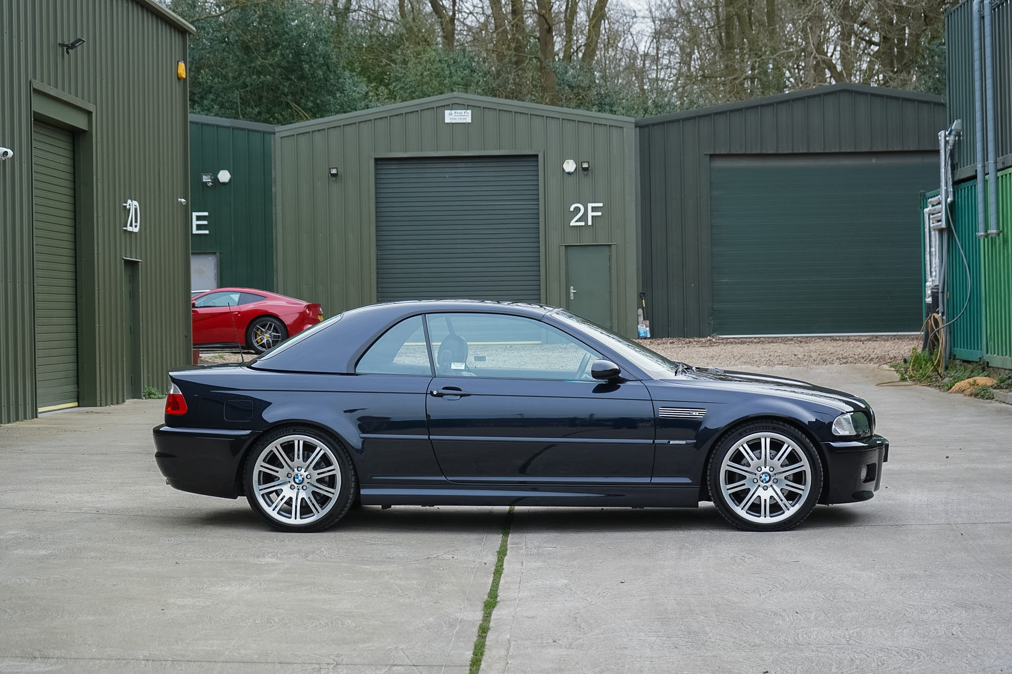 Dark blue BMW M3 (E46) full side profile.