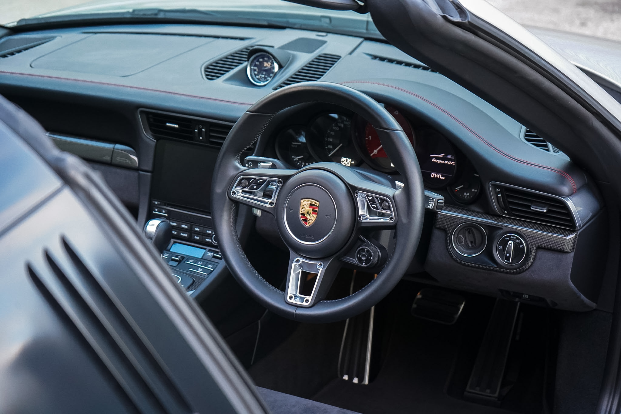 2018 Porsche 911 (991.2) Targa 4 GTS cockpit, steering wheel and dashboard high-angle view.