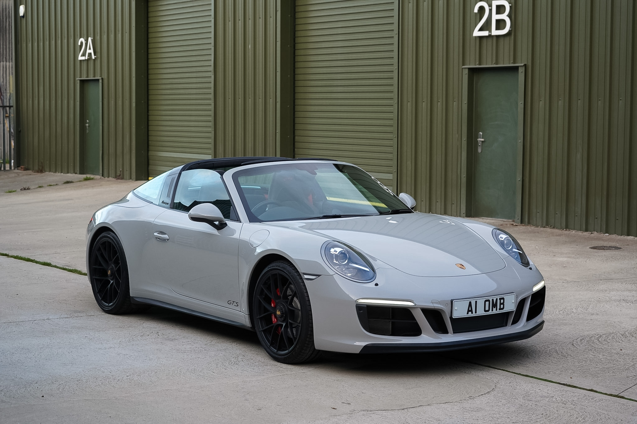 Silver 2018 Porsche 911 (991.2) Targa 4 GTS front three-quarter view.