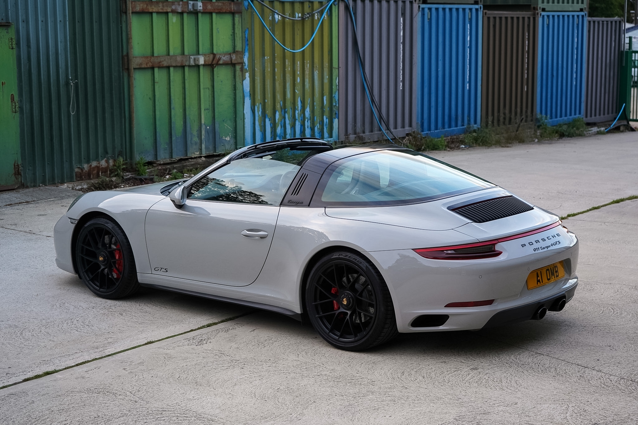 Silver 2018 Porsche 911 (991.2) Targa 4 GTS rear three-quarter view.