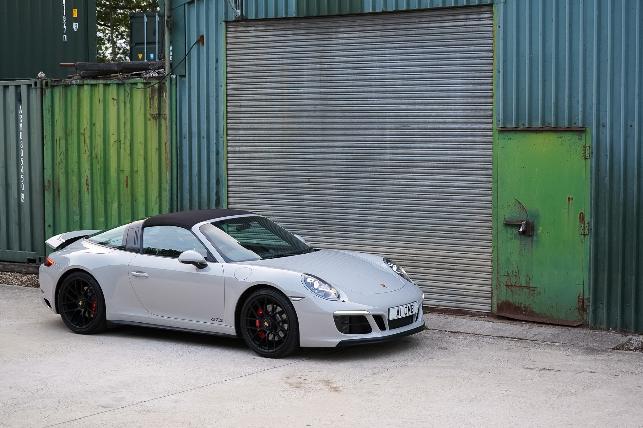 Silver 2018 Porsche 911 (991.2) Targa 4 GTS wide front three-quarter side view.