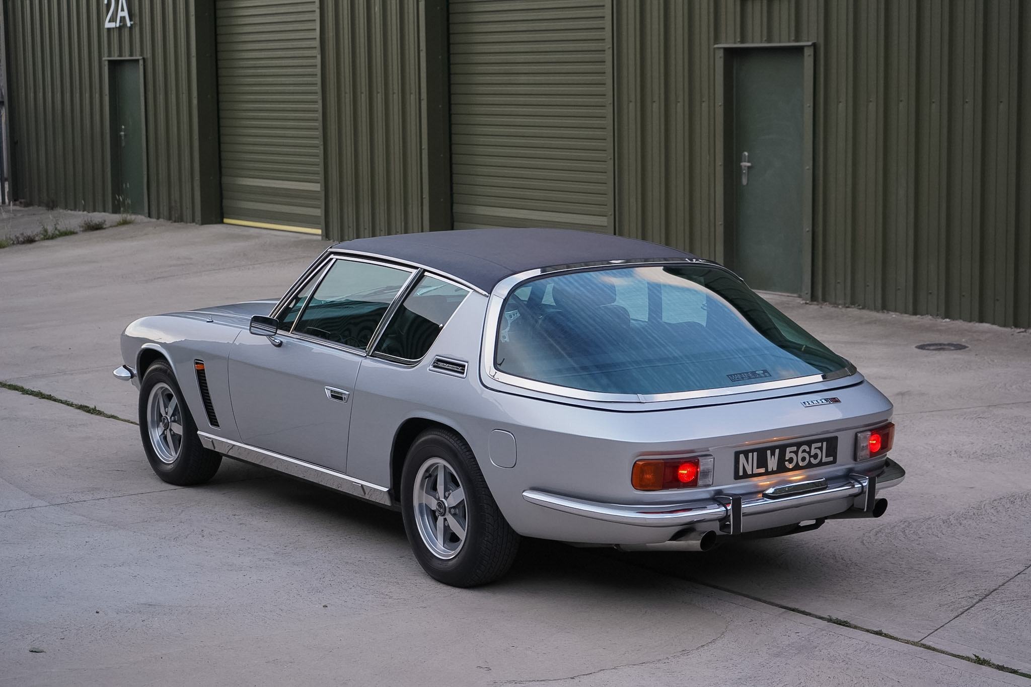 Silver Jensen Interceptor Mk III rear three-quarter view from the opposite side.